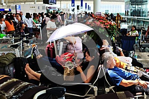 A lady helds an umbrella in Hong Kong airport