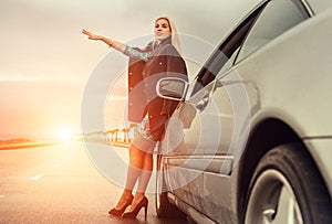 Lady in high heel shoes with broked car on the highway