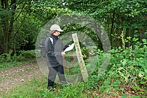Lady Hiker reading a Map on a Footpath