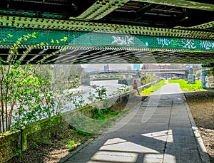 Lady hiker sitting under railway a bridge