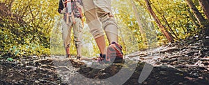 Lady hiker walking through the rocky land. Focus on the foot. Hiking shoes in action on a mountain desert trail path.