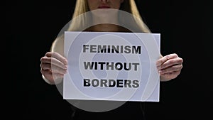 Lady holding feminism without border sign, equal women social rights stop sexism