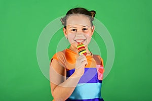 Lady holds long shaped lollipop. Treatment and sweets concept.