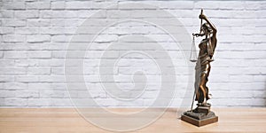 Lady Justice or Justitia statue on desk - legal law jurisdiction photo