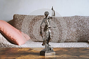 Lady justice or justitia statue on table - landlord and tenant law photo
