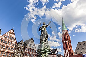Lady Justice at roemerberg in Frankfurt with half timbered house photo
