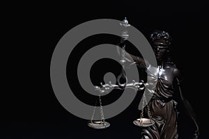 Lady Justice with scales of truth against black background. Conceptual image of justice, law and legal system. Copy space