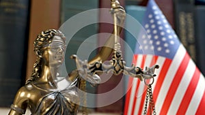 Lady justice symbol with USA flag and bookshelf background