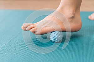 Lady kneading her feet with myo fascial release ball