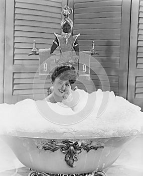 Lady of leisure soaks in a tub of bubbles