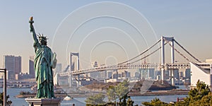 Lady liberty juxtaposed against Rainbow Bridge in Tokyo, Japan