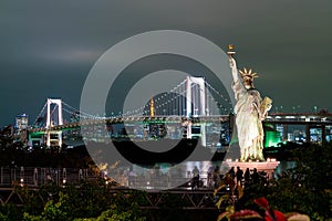 Lady liberty juxtaposed against Rainbow Bridge in Tokyo.