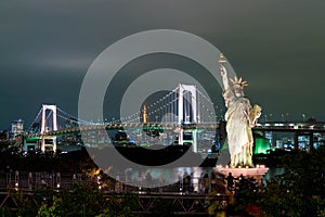 Lady liberty juxtaposed against Rainbow Bridge in Tokyo.