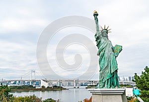 Lady liberty juxtaposed against Rainbow Bridge in Tokyo.