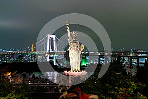 Lady liberty juxtaposed against Rainbow Bridge in Tokyo.