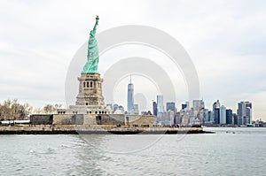 Lady Liberty Statue with Lower Manhattan Futuristic Buildings and Towers in Background. New York City, NY, USA