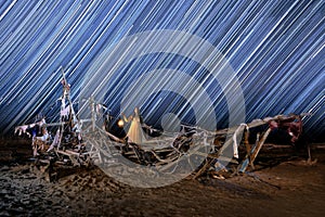 Lady Light Painted on a Ghost Ship With Star Trails on Beach