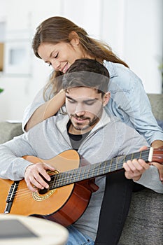 lady listening to boyfriend play guitar photo