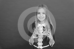 Lady little princess. Girl cute smile hold crown while stand red background. Best award for me. Kid hold golden crown