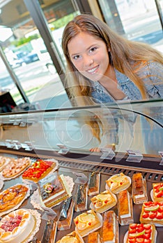 Lady looking at patisseries photo