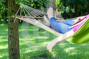 Lady lying with book on hammock