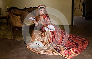 Lady in medieval dress sitting on floor