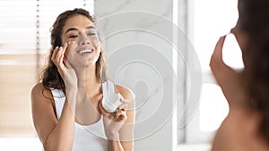 Lady Moisturizing Skin Applying Cream On Face In Bathroom, Panorama