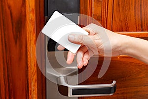 Lady opening an electronic door lock by blank security card