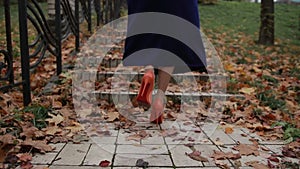 Lady in orange high heel shoes walking upstairs