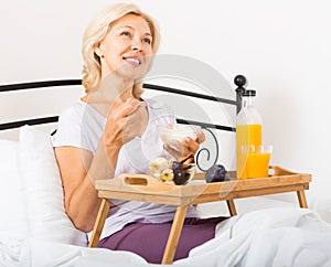 Lady with orange juice, berries and yogurt