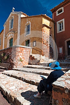 Lady painting Eglise Saint Michel fachade at Roussillon in Franc photo