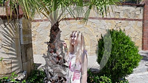 Lady, palm tree and sunny weather.