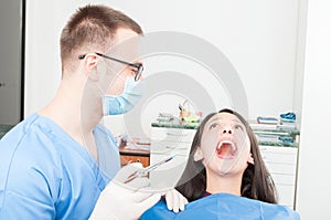 Lady patient at dentist ready to make anesthetic shot photo
