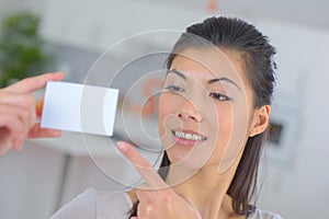 Lady pointing to blank business card