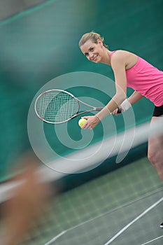 Lady poised to serve tennis ball