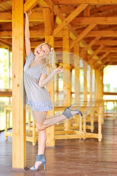 Lady posing near the wooden structure