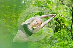 Lady practicing yoga in the nature.