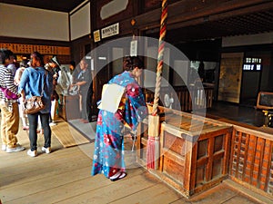 Lady praying in Kiyomizu Temple, Kyoto, Japan