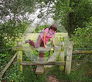 Lady Rambler climbing over a Stile