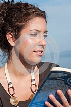 Lady reading a book at the seaside