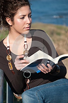 Lady reading a book at the seaside