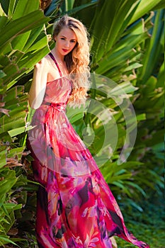 Lady in red bright dress in tropics