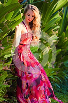 Lady in red bright dress in tropics