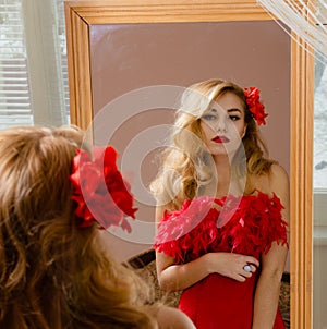 Lady in red dress with flower barrette looking in