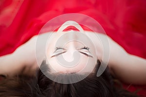 Lady in Red Dress Laying Down Eyes Closed Relaxed Sleeping