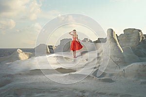 Lady in red dress in an unusual landscape