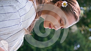 Lady relaxing sunny park standing greenery closeup. Woman in forest vertically