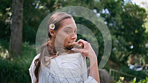 Lady relaxing sunny park standing at greenery closeup. Woman posing green forest