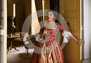 Lady in renaissance gown entering room