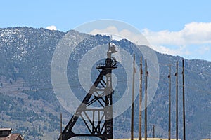 Lady of the Rockies overlooking the derricks of mining